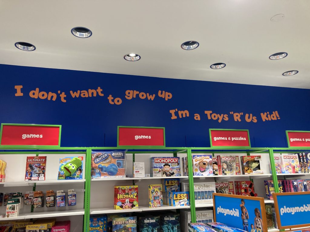 "I don't want to grow up I'm a Toys R Us Kid!" is painted above some shelving. This the famous Toys R Us slogan.