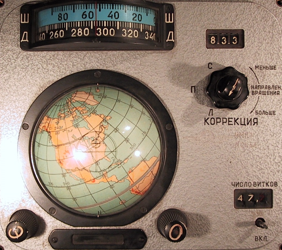 A picture of the  IMP "Globus" navigation instrument for the Voskhod spacecraft. The instrument features a mini globe, as well as some dials and knobs.